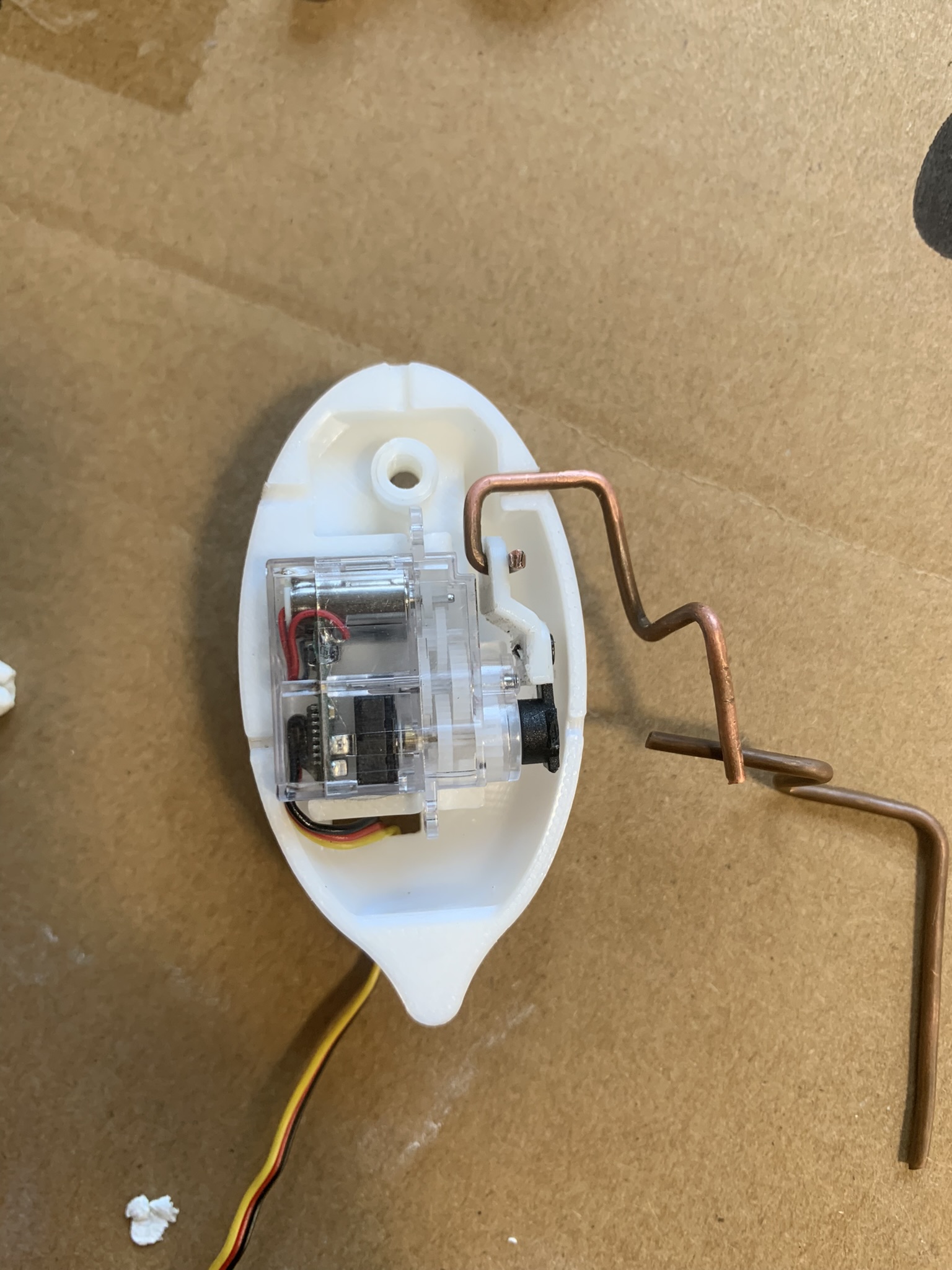 The prop used a 3D printed torso that housed a small servo. The servo connected to the copper wire armature to create a twitching motion.