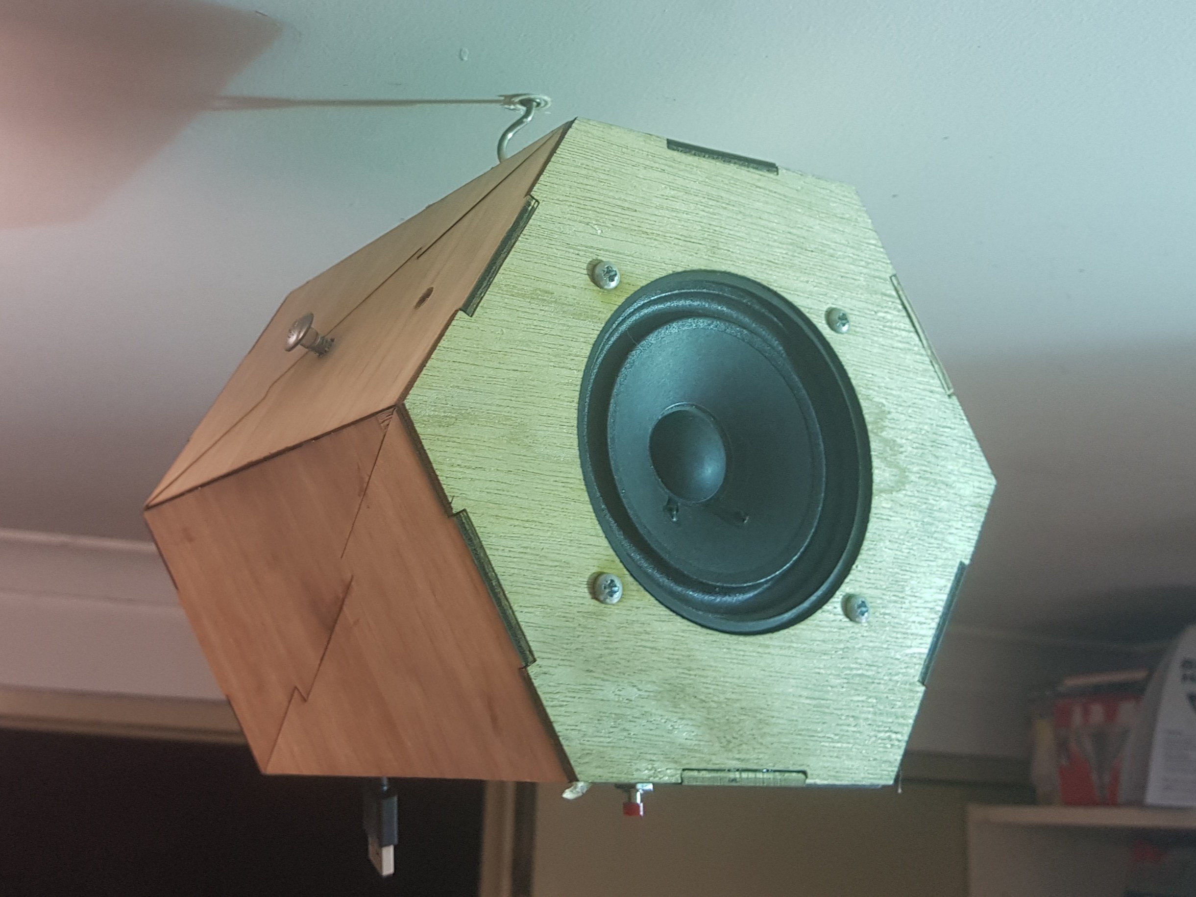 The final design was laser cut from 3mm plywood, and could be hung from the ceiling. The electronics from an off-the-shelf DIY kit were soldered and fitted.