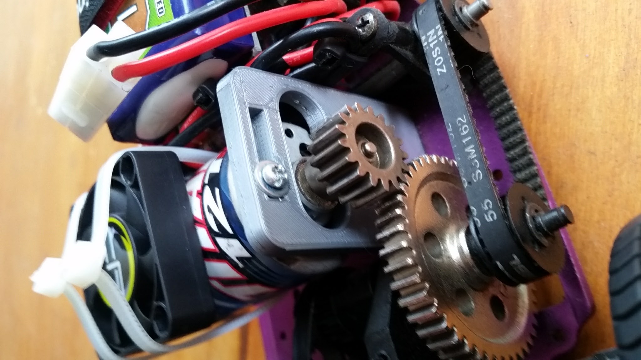 The initial conversion used a 3D printed motor mount designed in Onshape, with an aluminum battery tray, and brushed electronics.