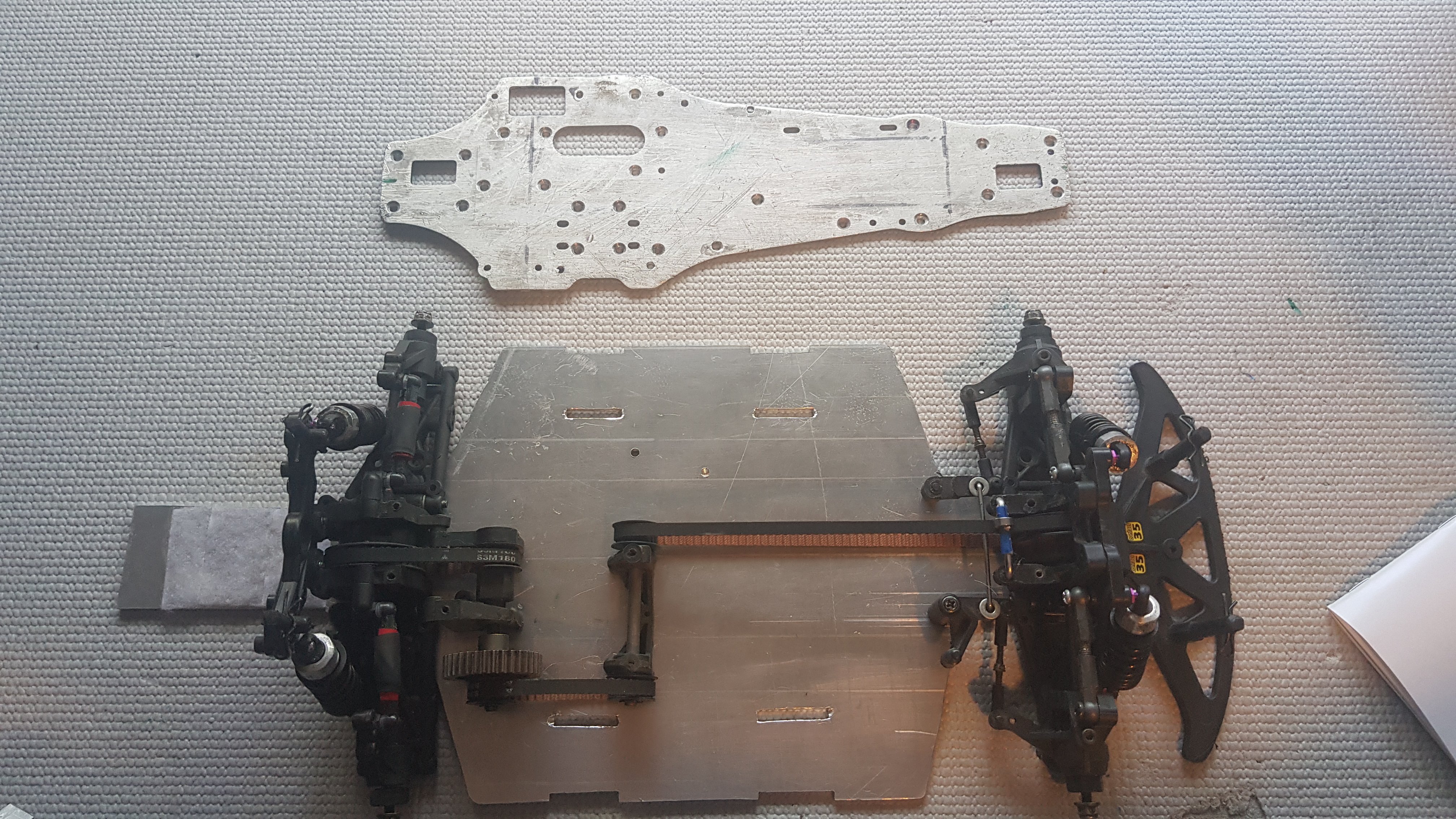 Despite the crash being minor, I decided to take what I'd learnt and completely rebuild the car. I a designed a new widened chassis, and with a lazercut template cut it from 3mm aluminium on my scroll saw.