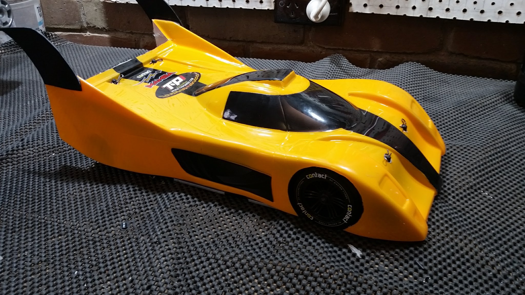 I used an aerodynamic body shell based on the Toyota GT-One. The body was reinforced with fibreglass to stiffen the thin polycarbonate. I also made and attached vertical fins to the rear for additional stability.